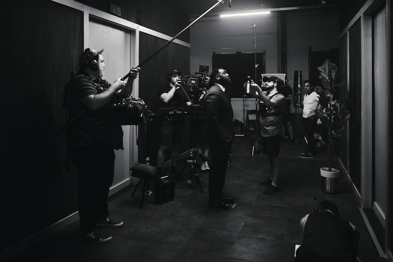 The crew lighting and filming a scene on the OPEN DOOR set
